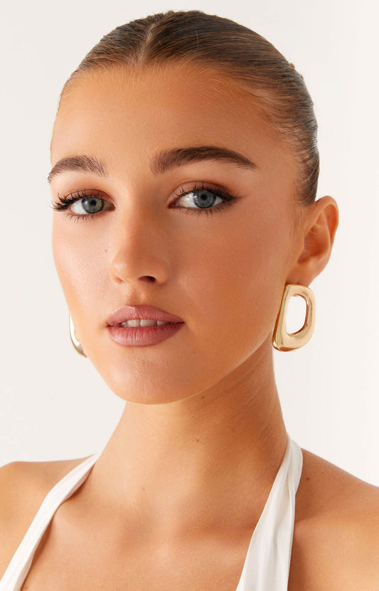 A woman wearing earrings from Peppermayo women's accessories collection