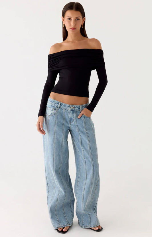 A woman wearing white top and pink skirt from Peppermayo's women's bottoms collection