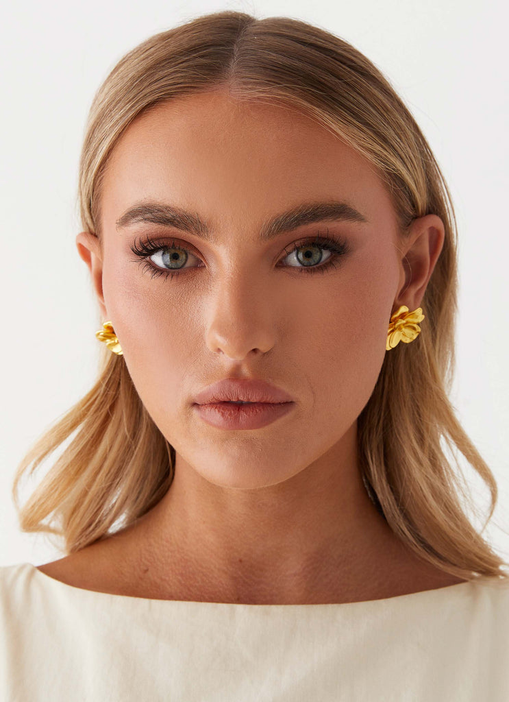 Womens Bold Rosette Earrings in the colour Gold in front of a light grey background