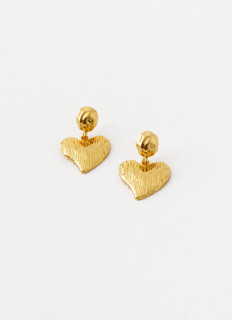 Womens Commitment Heart Earrings in the colour Gold in front of a light grey background