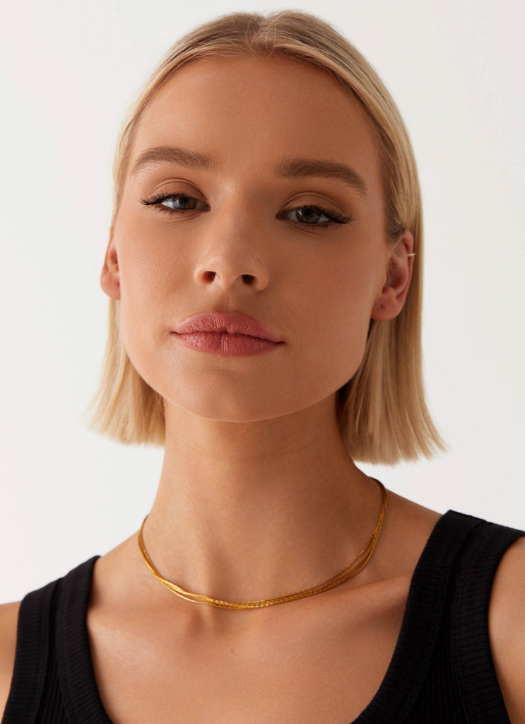 Womens Head Held High Necklace in the colour Gold in front of a light grey background