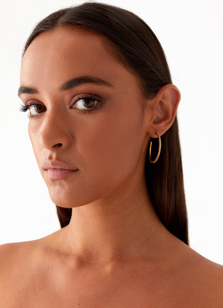 Womens Lilyanna Earrings in the colour Gold in front of a light grey background