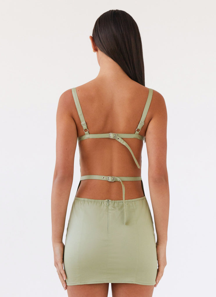 Womens Naomi Backless Mini Dress in the colour Sage in front of a light grey background