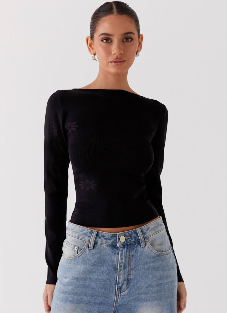 Womens Dandelion Long Sleeve Knit Top in the colour Black in front of a light grey background