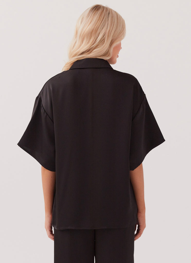 Womens Palm Cove Satin Shirt in the colour Black in front of a light grey background