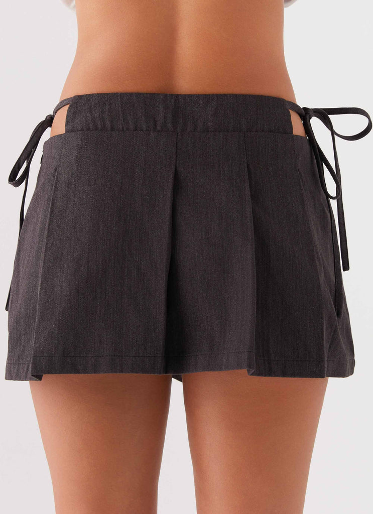 Womens Alexie Pleated Mini Skirt in the colour Black in front of a light grey background