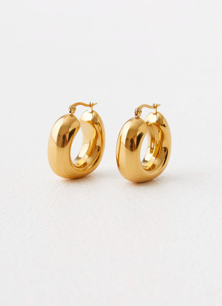 Womens Sweet Distraction Earrings in the colour Gold in front of a light grey background