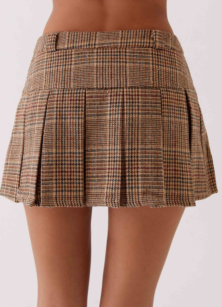 Womens Danica Pleated Mini Skirt in the colour Brown Check in front of a light grey background