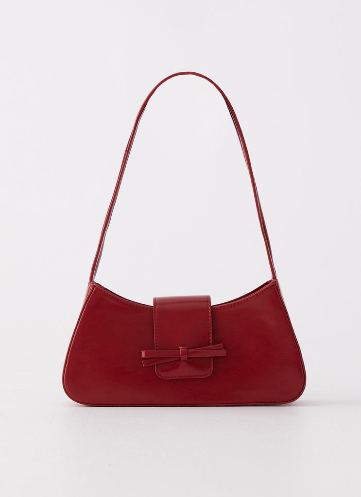 Womens Cara Bow Shoulder Bag in the colour Red in front of a light grey background