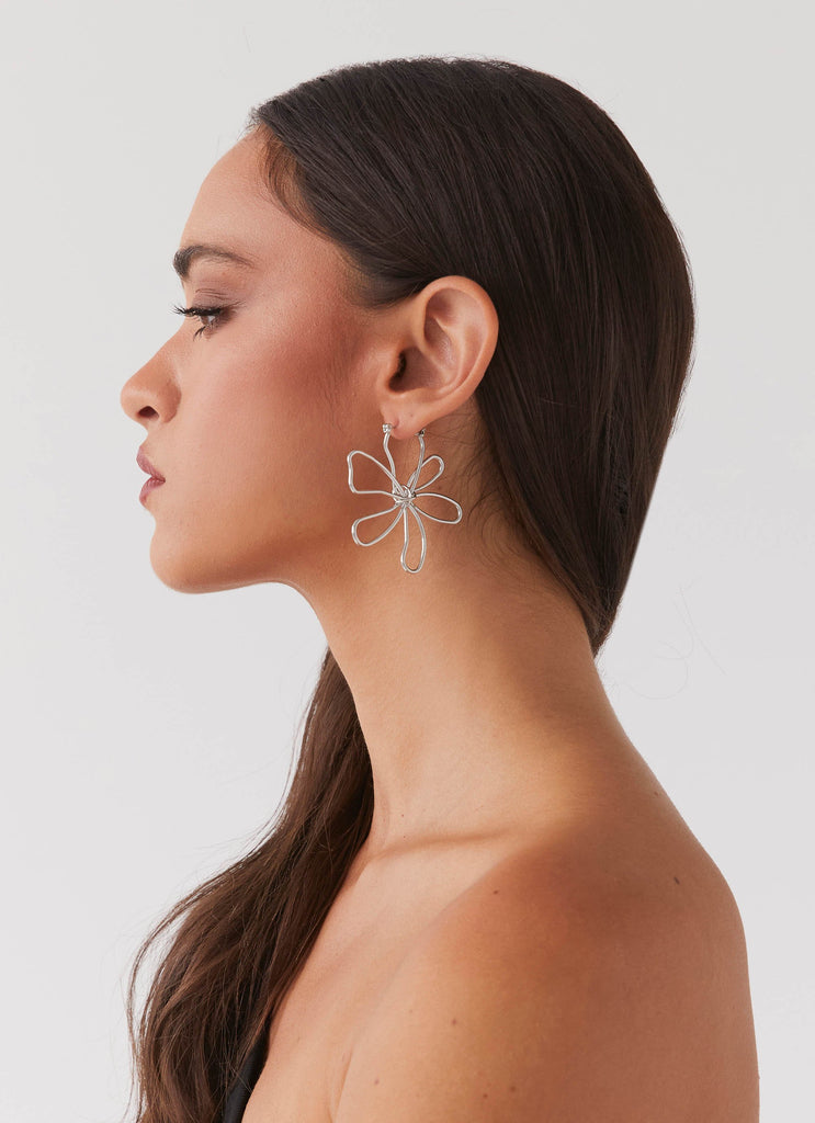 Womens Sylvie Flower Hoop Earrings in the colour Silver in front of a light grey background