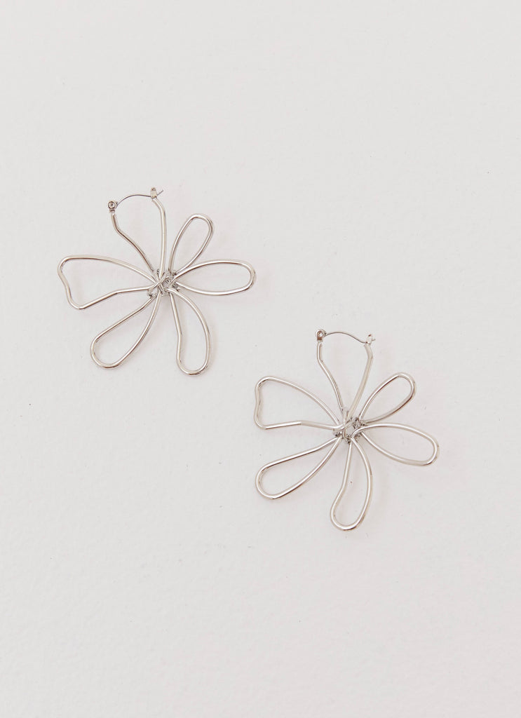 Womens Sylvie Flower Hoop Earrings in the colour Silver in front of a light grey background