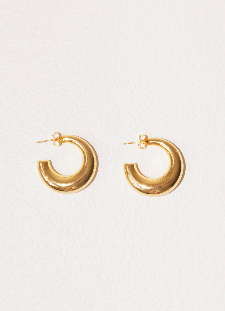 Womens Calisse Hoop Earrings in the colour Gold in front of a light grey background